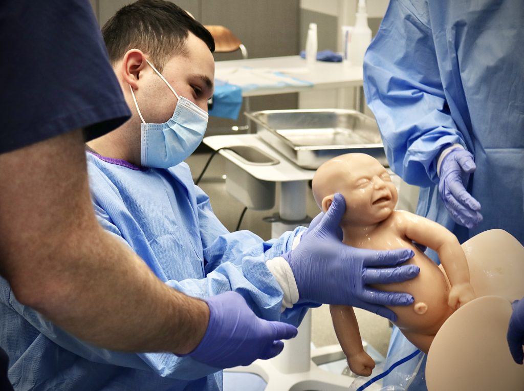 Kevin Riviera, second-year medical student at TCU and UNTHSC School of Medicine, delivers a newborn mannikin during a child birthing simulation session on March 4, 2021.