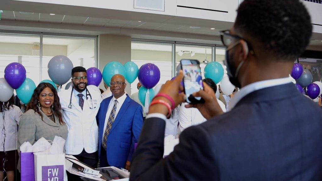 First-year medical student James Okpamen and his family at the TCU and UNTHSC School of Medicine White Coat Celebration at TCU Legends Club at Amon G. Carter Stadium, on Saturday, August 7, 2021.