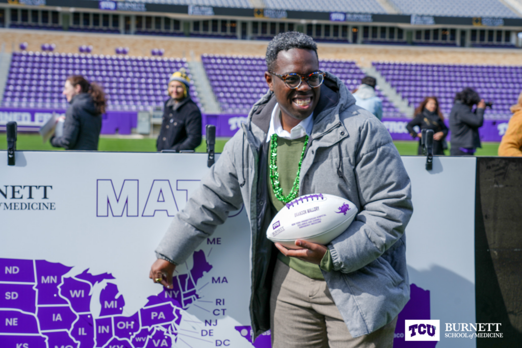 Brandon Mallory, MS4, pins his residency match at Burnett School of Medicine's Match Day 2023 at Amon G. Carter Stadium at Texas Christian University in Fort Worth, Texas on Friday, March 17, 2023.