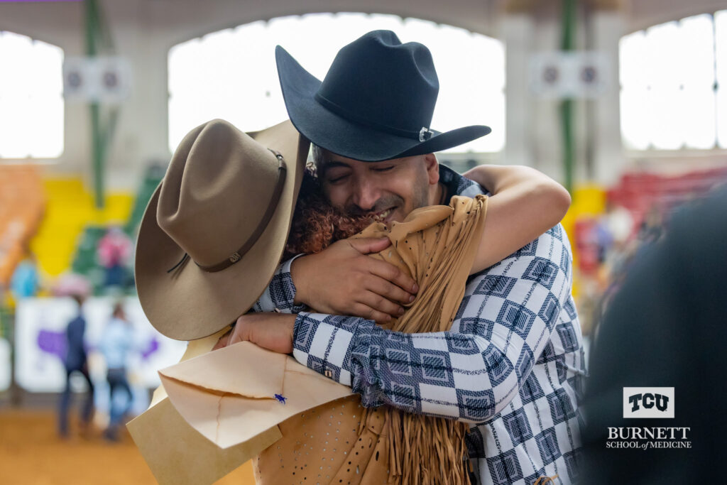 Sam Sayed, MS4, hugs his daughter after finding out his Match Day results at Cowtown Coliseum in Fort Worth on March 15, 2024.