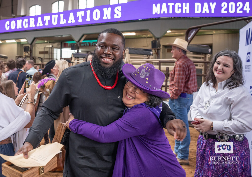 Toni Igbokidi, MS4, hugs Yolanda Becker, Director of Career and Professional Development, at Match Day at the Cowtown Coliseum in Fort Worth, Texas on March 15, 2024.