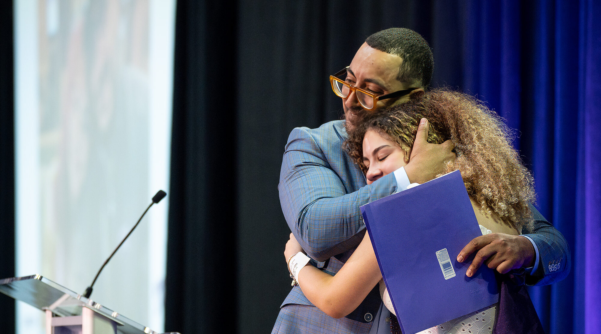 Sam Sayed, MS4, at the Anne Burnett Marion School of Medicine at Texas Christian University, embraces his daughter Sophie at TCU's 34th Annual Scholarship Dinner at Schollmaier Arena on April 17, 2024.