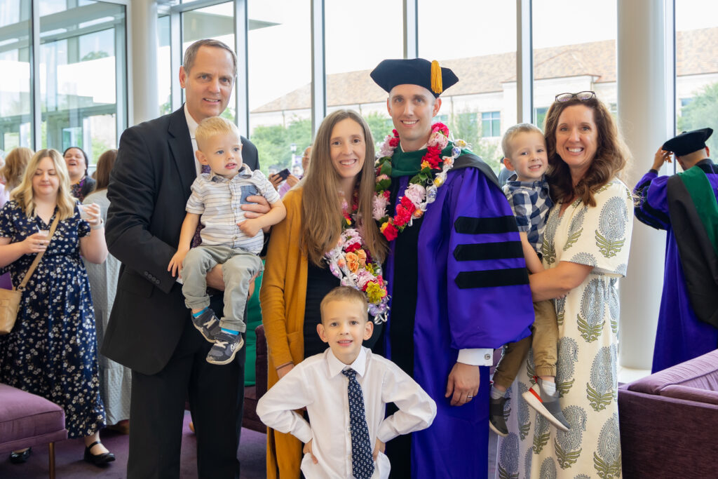 Caden Duffy, M.D., (center in regalia) with his family members. 