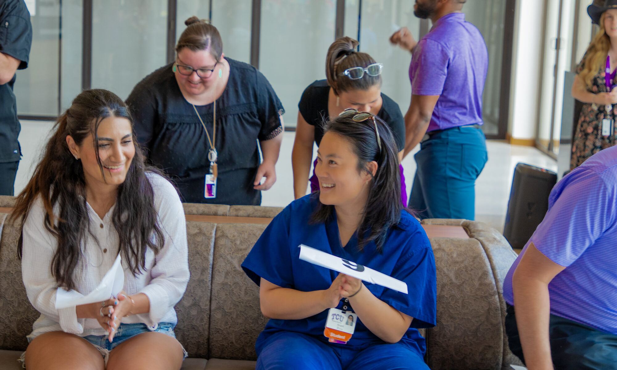 Burnett School of Medicine students Raika Bourmand and Angel Sheu laugh during the cake walk.