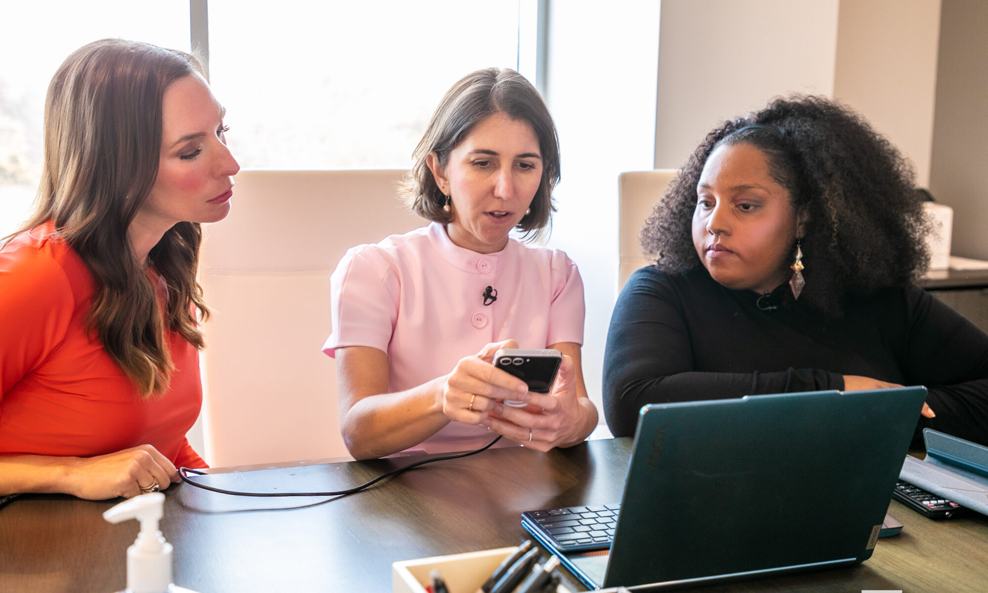 L-R: Sara Redington, Chief Philanthropy Officer for The Miles Foundation; Sadie Funk, National Director of The Best Place For Kids®; and Onia Mayberry-Wallace look at the features of the Parent Pass app.