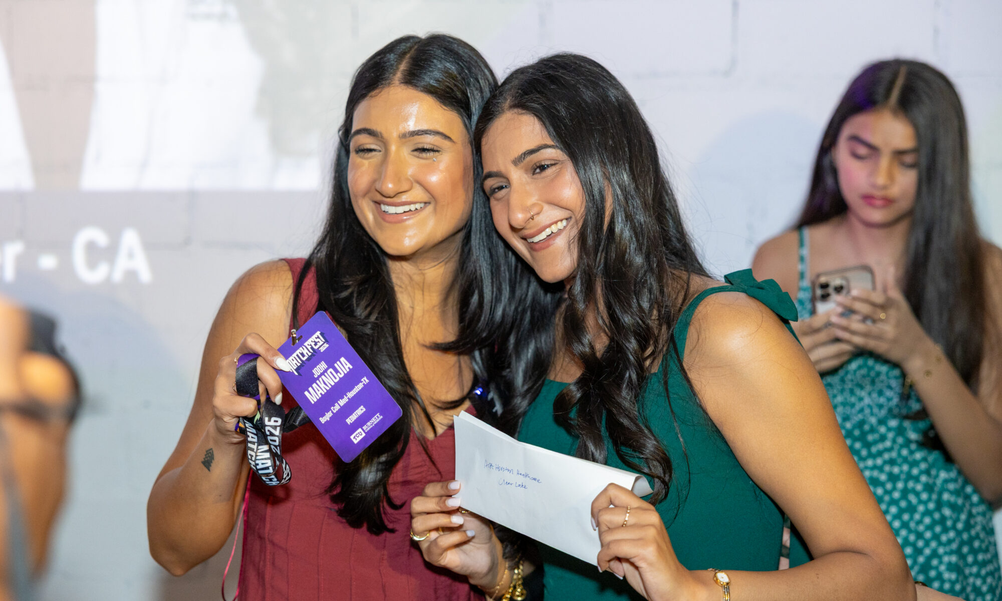 Joohi Maknojia, MS4, left, and her twin sister, Roohi, who attends University of Houston medical school, find out that they are both staying in Texas for their residencies.